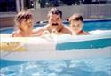 With Daughter Norma Jean and son Charlie in backyard pool (1994)